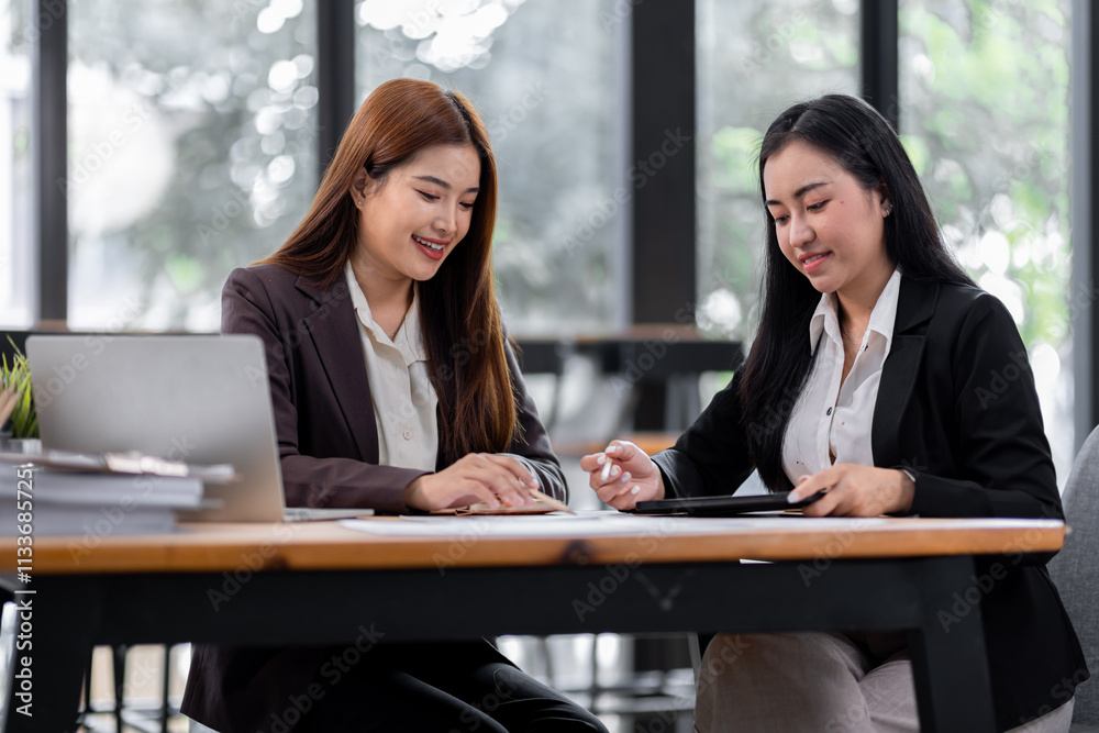 Business financing accounting banking concept. Two asian Business doing finances and calculate on desk about cost at workplace. Business working on desk with using calculator, finance accounting.
Business financing accounting banking concept. Two asian Business doing finances and calculate on desk about cost at workplace. Business working on desk with using calculator, finance accounting.