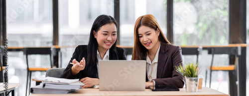 Wallpaper Mural Business financing accounting banking concept. Two asian Business doing finances and calculate on desk about cost at workplace. Business working on desk with using calculator, finance accounting.
 Torontodigital.ca