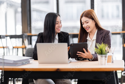 Business financing accounting banking concept. Two asian Business doing finances and calculate on desk about cost at workplace. Business working on desk with using calculator, finance accounting. 