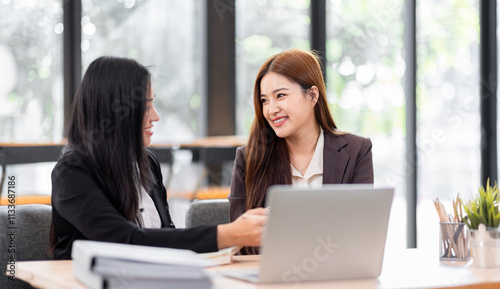 Business financing accounting banking concept. Two asian Business doing finances and calculate on desk about cost at workplace. Business working on desk with using calculator, finance accounting. 