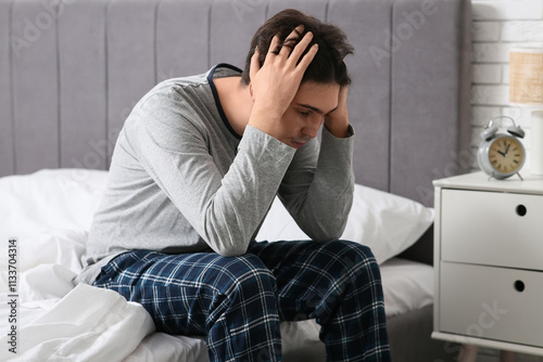 Depressed young man sitting...