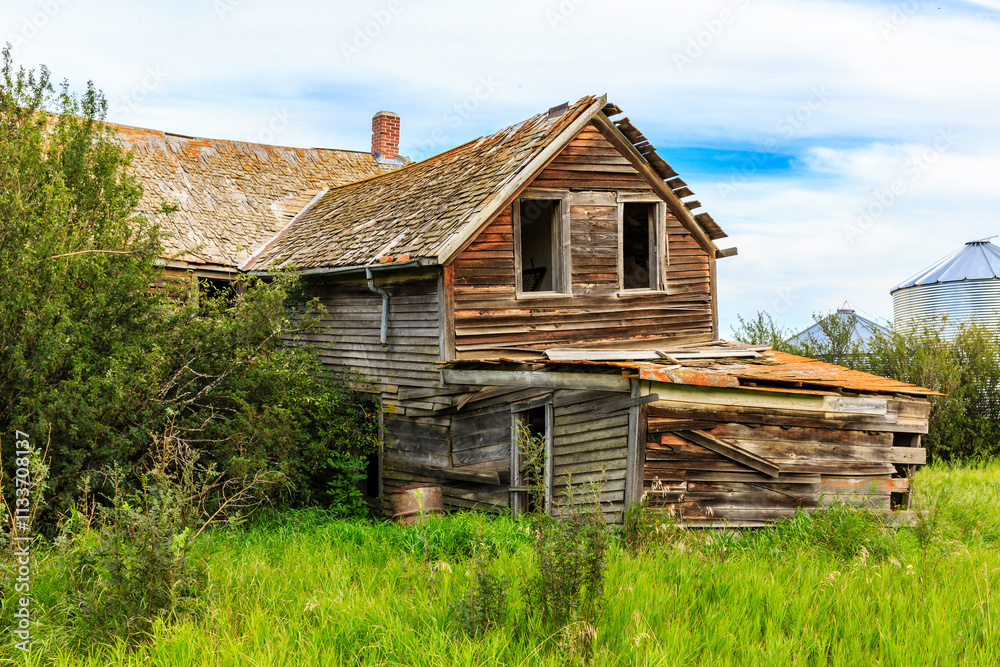 A dilapidated old house with a large chimney A dilapidated old house with a large chimney