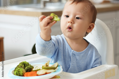 Cute little baby eating fre...