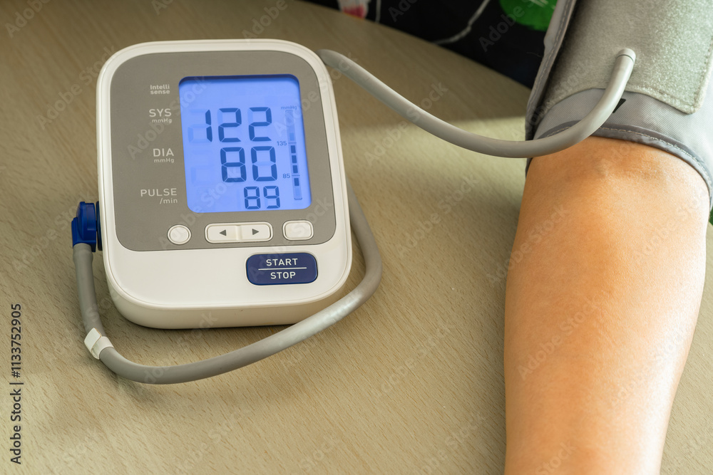 Woman check blood pressure monitor and heart rate monitor with digital pressure gauge. Health care and Medical concept
Woman check blood pressure monitor and heart rate monitor with digital pressure gauge. Health care and Medical concept