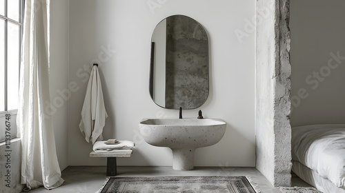 Minimalist bathroom with a vintage-style mirror, soft rugs, and a wall-mounted sink,