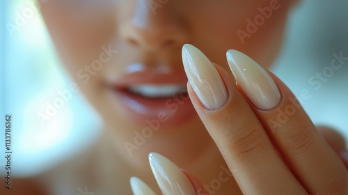 Close-up of a person showcasing elegant, manicured nails and a bright smile.