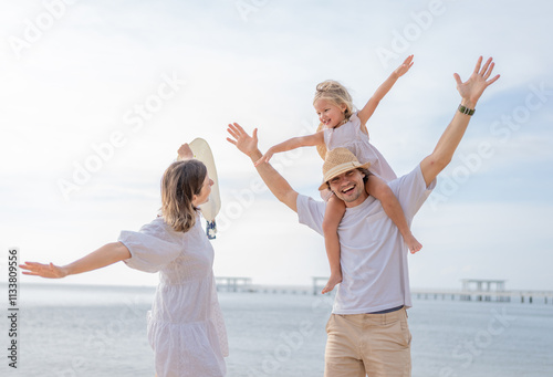 Happy family enjoying vacation on the beach together having fun on summer vacation.