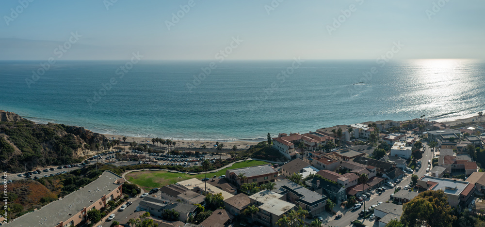 Fototapeta premium Panoramic aerial views of San Clemente coastline showcasing vibrant ocean, and sandy beach over The Loop