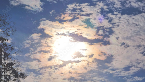 Sky photo showing a natural bright morning sun rising through the clouds floating in the air, Central Thailand.