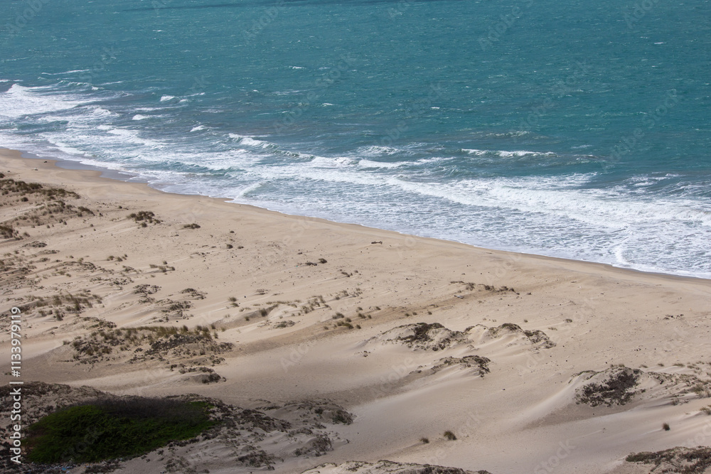 Dhanushkodi Beach, located near Arichal Munai, is known for its pristine sands and clear waters. Dhanushkodi is an abandoned town at the south-eastern tip of Pamban Island of the state of Tamil Nadu Dhanushkodi Beach, located near Arichal Munai, is known for its pristine sands and clear waters. Dhanushkodi is an abandoned town at the south-eastern tip of Pamban Island of the state of Tamil Nadu