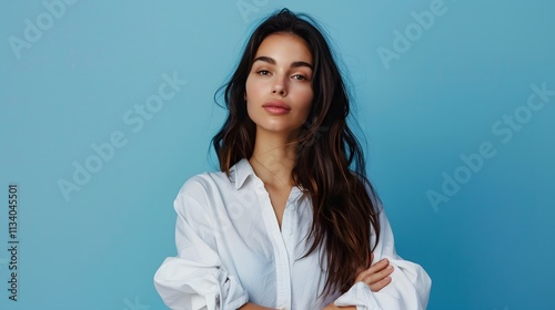 Portrait of a Confident Woman with Long Hair in Front of Blue Background