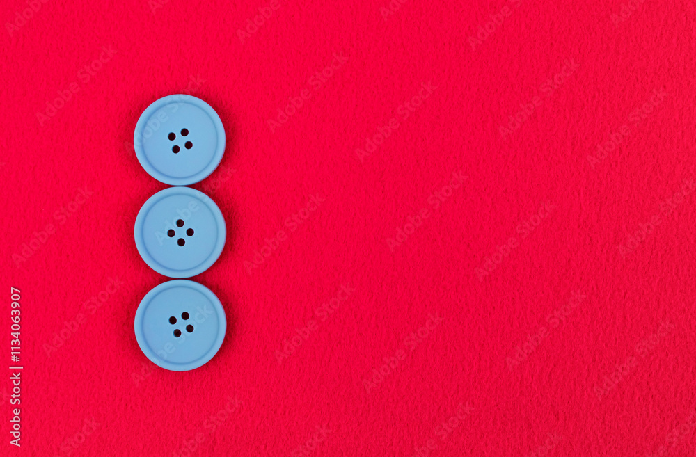 Three blue buttons on pink fleece fabric Three blue buttons on pink fleece fabric
