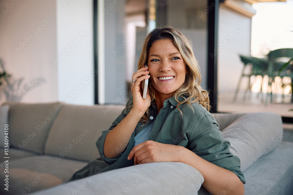 Happy woman talking on mobile phone phone while relaxing at home. Happy woman talking on mobile phone phone while relaxing at home.