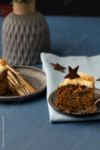 Gold cutlery and plate with slice of Cake and light blue serviette