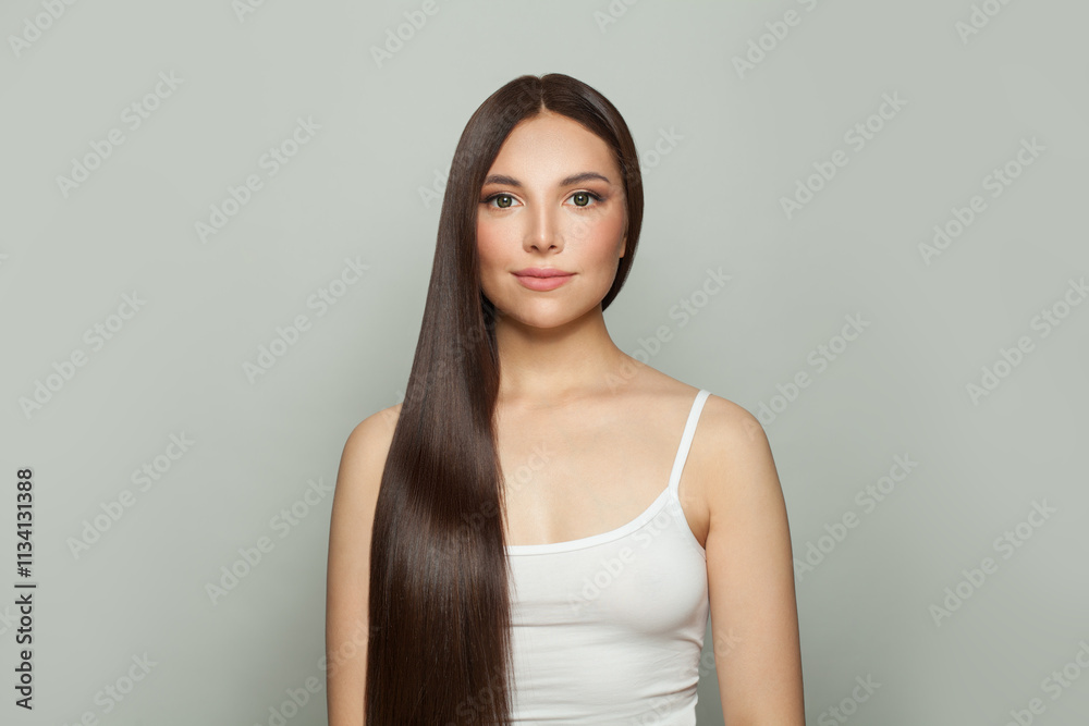 Glorious model woman with sleek long shiny brown hair. Cosmetology, hair and skin care, keratin treatment care and spa concept Glorious model woman with sleek long shiny brown hair. Cosmetology, hair and skin care, keratin treatment care and spa concept