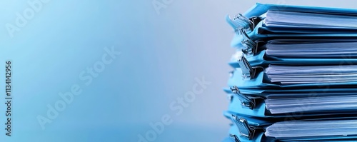 A stack of blue files with paper documents, suggesting organization and paperwork.
