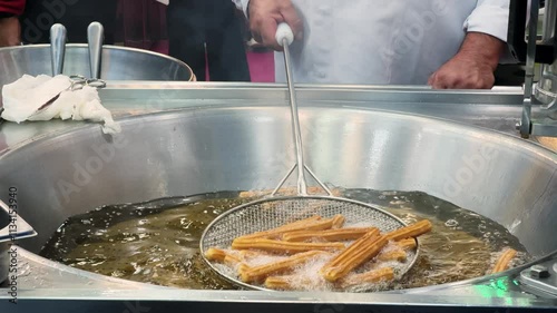 Fresh traditional Spanish dessert Churros. Deep fried churros at farmers market. Street Food. 