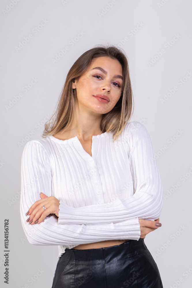 Close-up portrait of attractive brunette young woman standing on a white background. Copy space Close-up portrait of attractive brunette young woman standing on a white background. Copy space