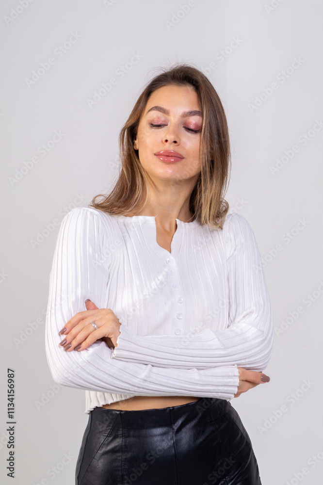 Close-up portrait of attractive brunette young woman standing on a white background. Copy space Close-up portrait of attractive brunette young woman standing on a white background. Copy space