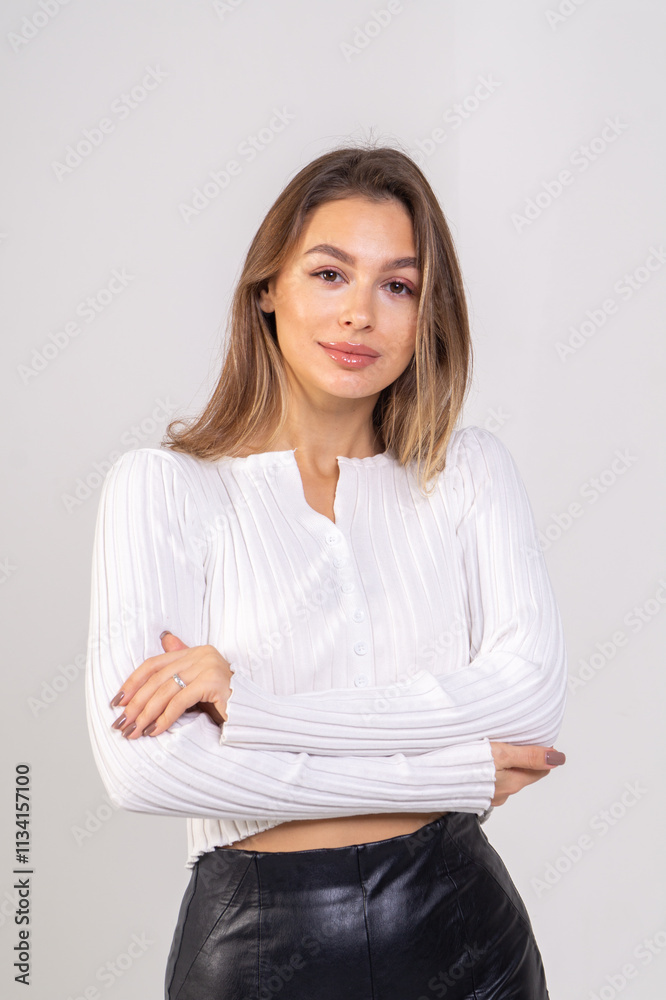 Close-up portrait of attractive brunette young woman standing on a white background. Copy space Close-up portrait of attractive brunette young woman standing on a white background. Copy space