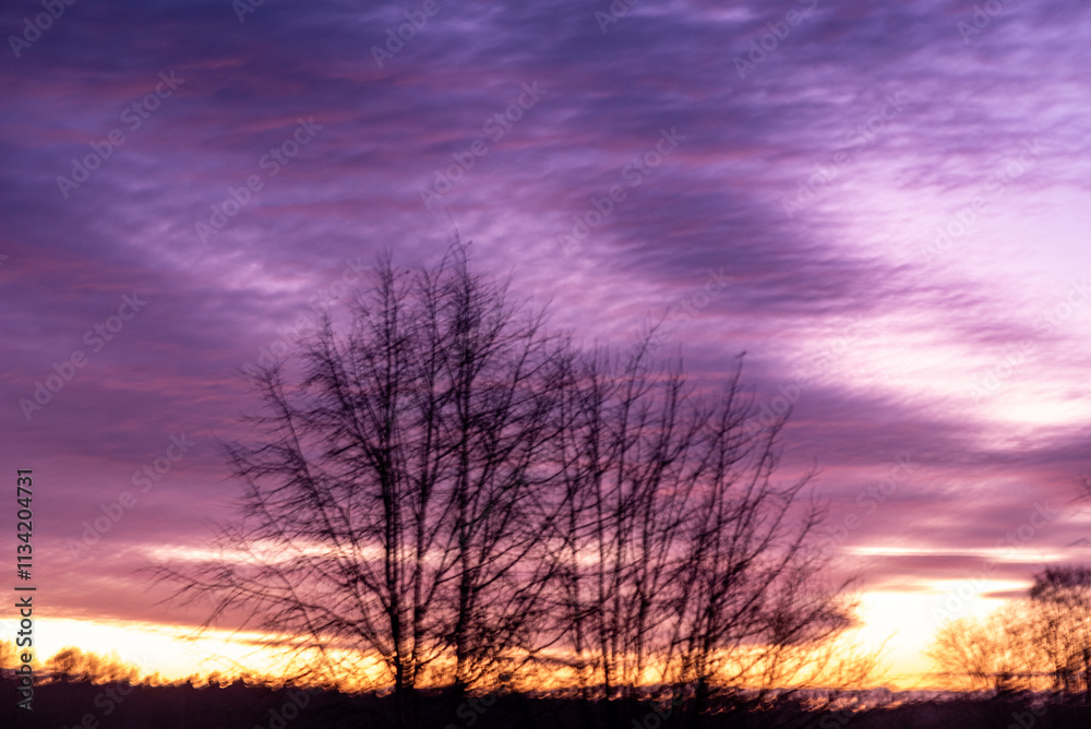 Fototapeta premium colorful sunrise sky outside the window, colorful play of light, shadows and reflections on the window glass, blurred outlines