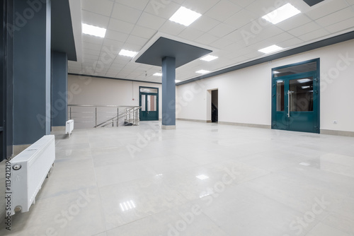 panorama view in empty modern hall with columns  doors and panoramic windows at night