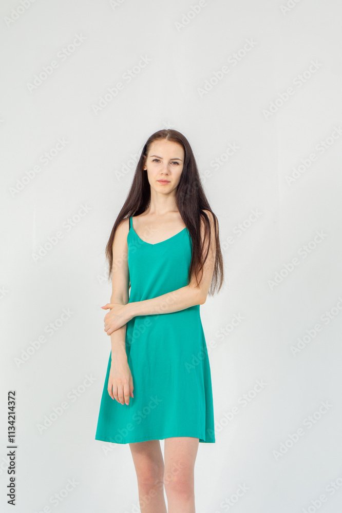 Slim cute young woman standing on a white background. Copy space Slim cute young woman standing on a white background. Copy space