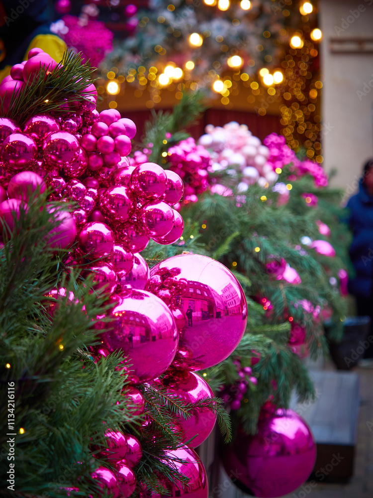 Fototapeta premium Christmas card with a tree, large pink Christmas balls and bright lanterns