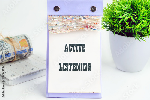 The concept of business and development. Conceptual text, phrase, words ACTIVE LISTENING It is written on a piece of desktop calendar on a white background photo