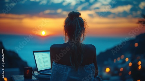 Young business woman working at the computer in cafe on the rock. Young girl downshifter working at a laptop at sunset or sunrise on the top of the mountain to the sea, photo