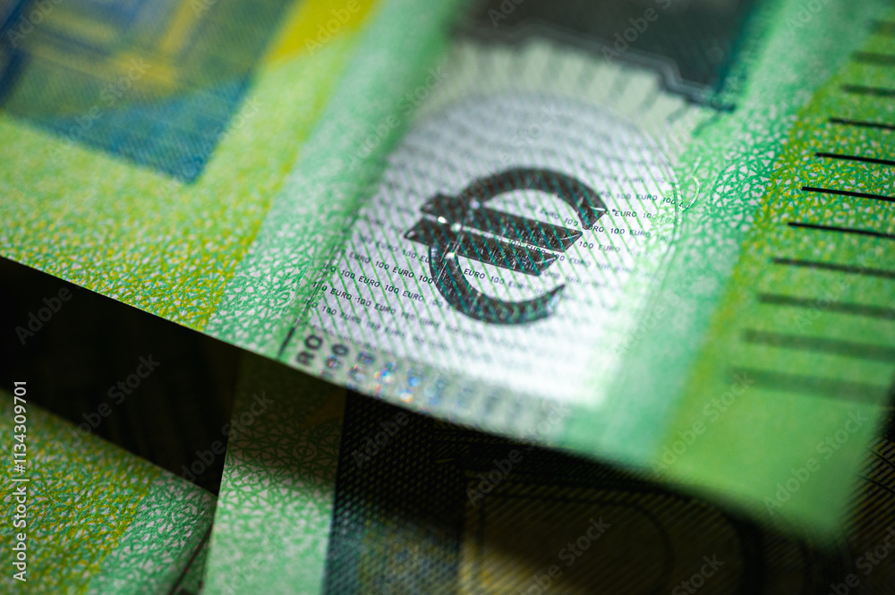 Close-up of a crisp 100 euro bill showing security elements and intricate design. Useful for themes like money, wealth, finance, banking, and European currency