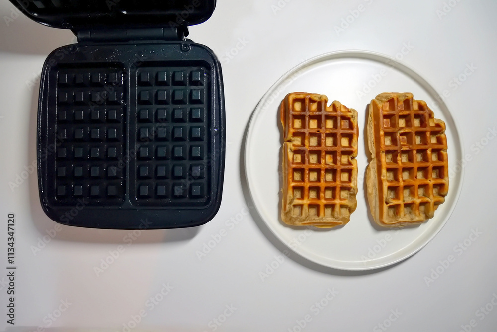A waffle iron for making waffles. Details and close-up of the waffle iron A waffle iron for making waffles. Details and close-up of the waffle iron