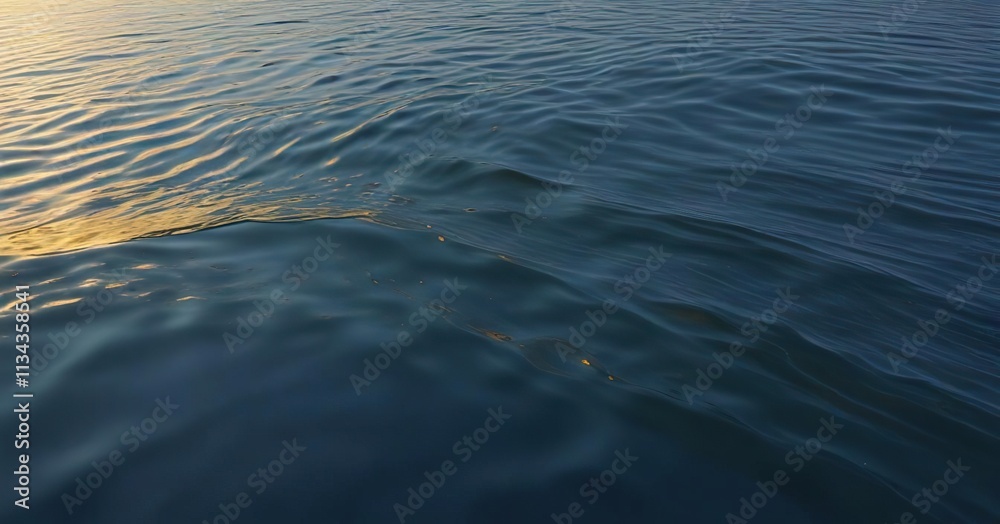 Naklejka premium A serene wave floats across the calm surface of a lake in an abstract blue and gold gradient background, peaceful, serenity