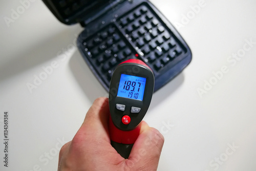 A pyrometer for measuring temperature. Photo of the temperature on the pyrometer photo