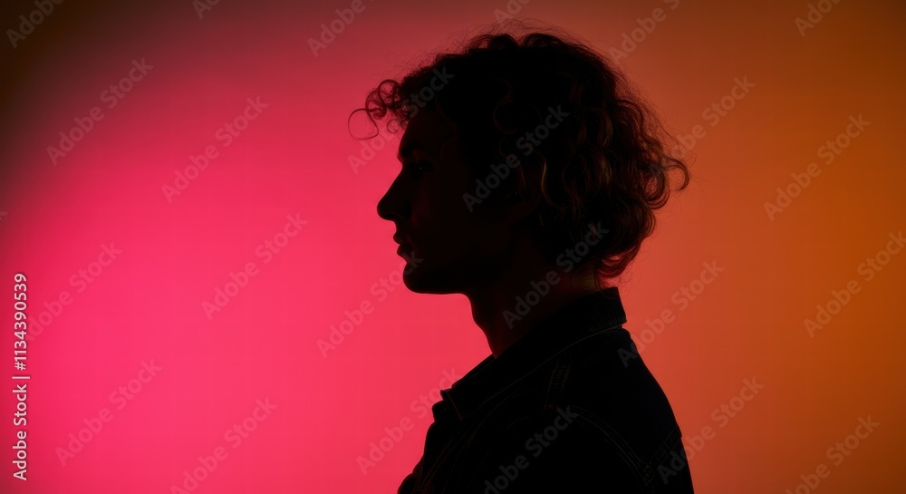 Silhouette of young caucasian male against vibrant gradient background Silhouette of young caucasian male against vibrant gradient background