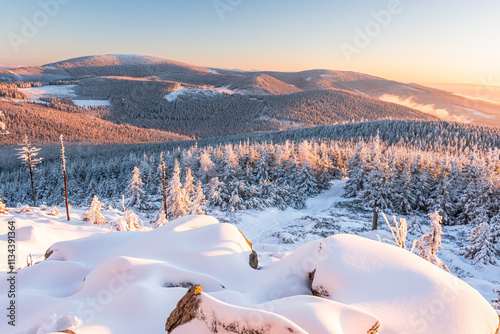 Obraz na płótnie Eastern Sudetes, View of snowy mountain range from hiking trail during winter hike in the mountains, viewpoint of wide winter landscape in the mountains at sunset. w salonie