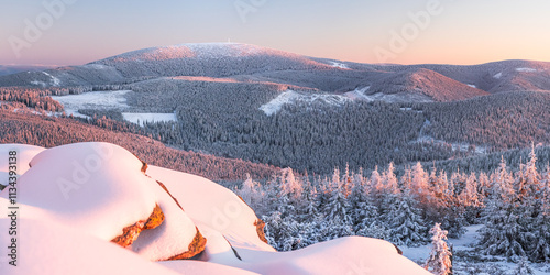 Obraz na płótnie Eastern Sudetes, View of snowy mountain range from hiking trail during winter hike in the mountains, viewpoint of wide winter landscape in the mountains at sunset. w salonie