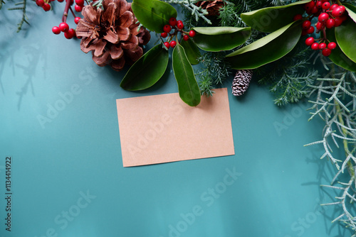 winter holiday natural leaves, berries and pine cone decoration background. winter holiday and Merry Christmas decorative background with greeting card.