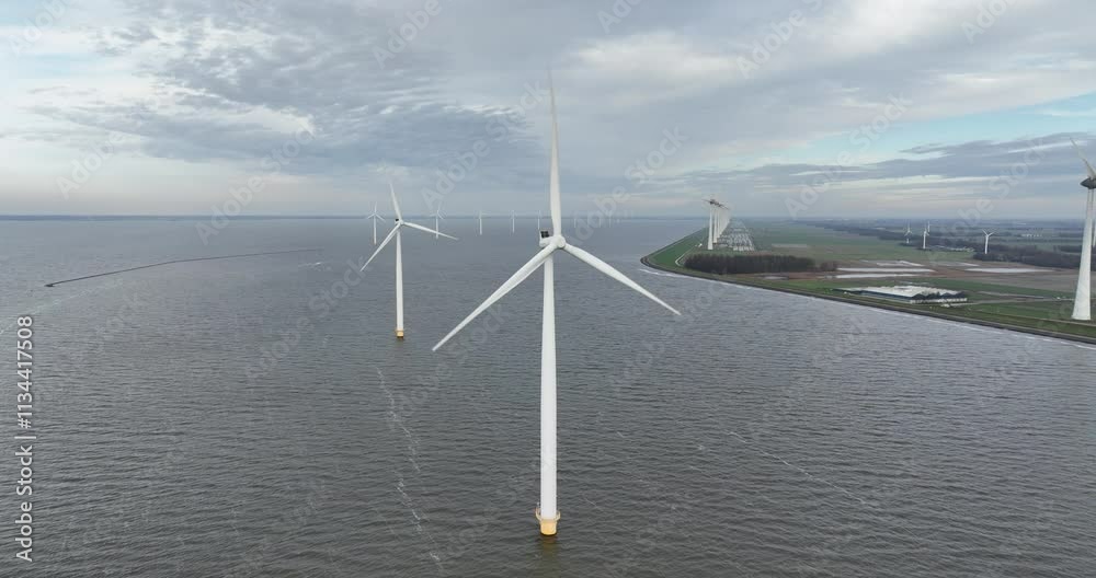 Aerial drone video on renewable energy, wind turbine on water, off shore wind park. Sustainbale energy system. Wind power.