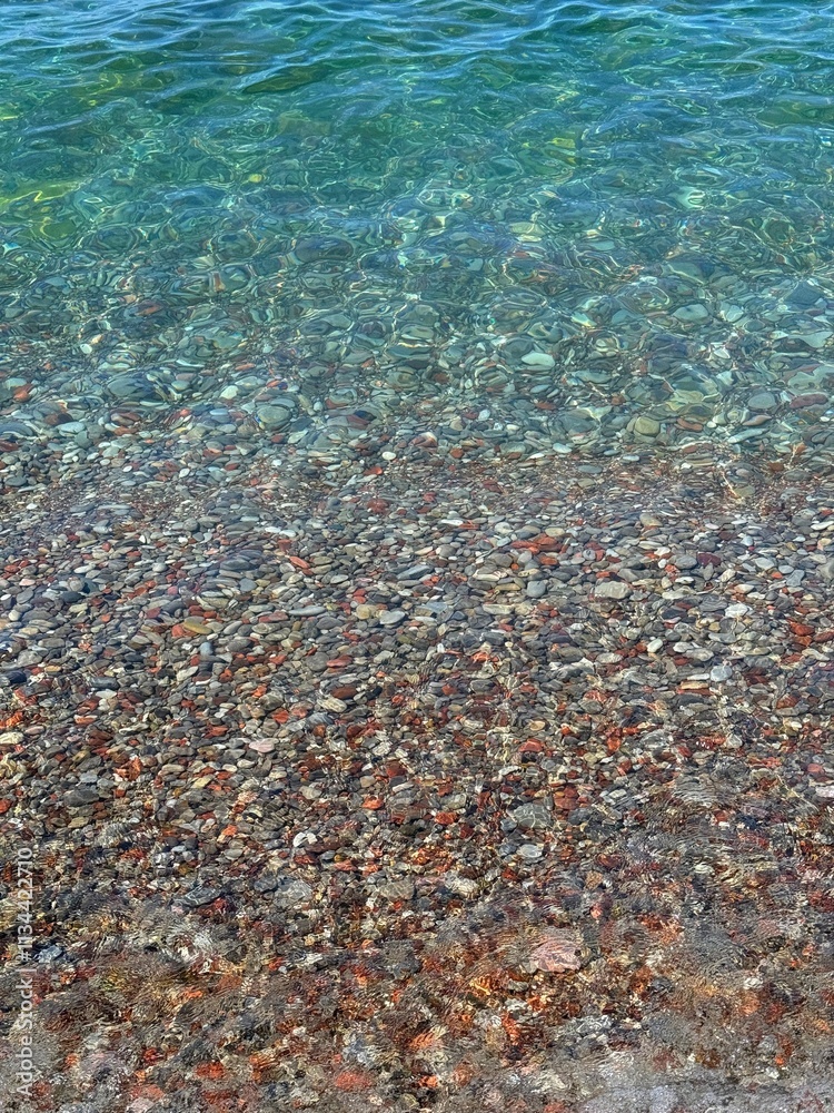 Clear blue sea waves on pebble beach. Clear blue sea waves on pebble beach.