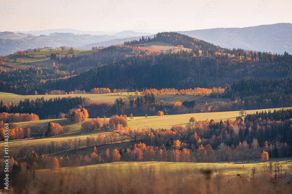 Czech Republic, Stribrnice, view from the Stvanice peak on the mountain landscape. Autumn panorama of the hills and fields in the late evening.
