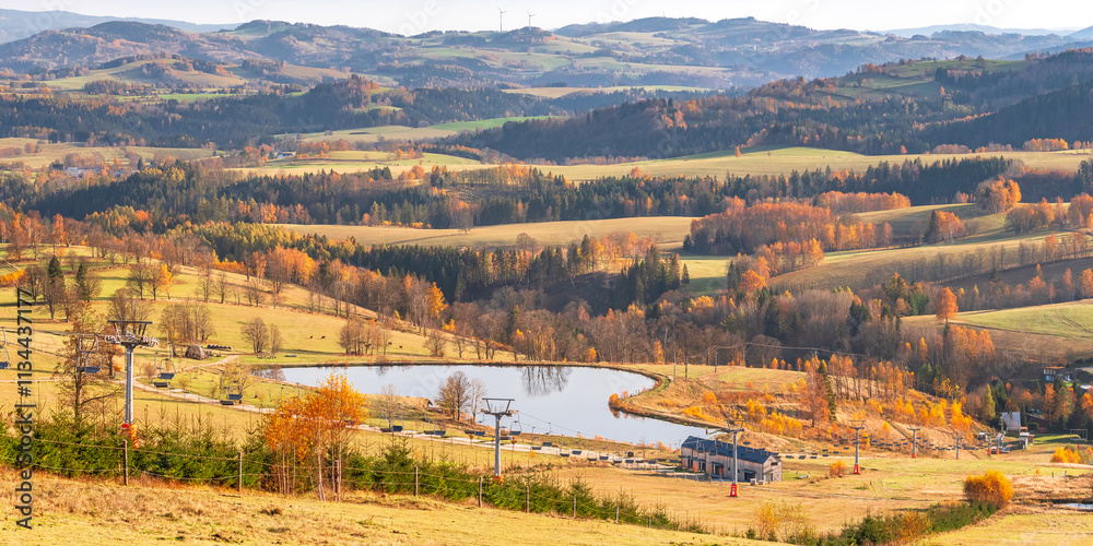 Czech Republic, Stribrnice, view from the Stvanice peak on the mountain landscape with a reservoir. Autumn landscape in the evening.