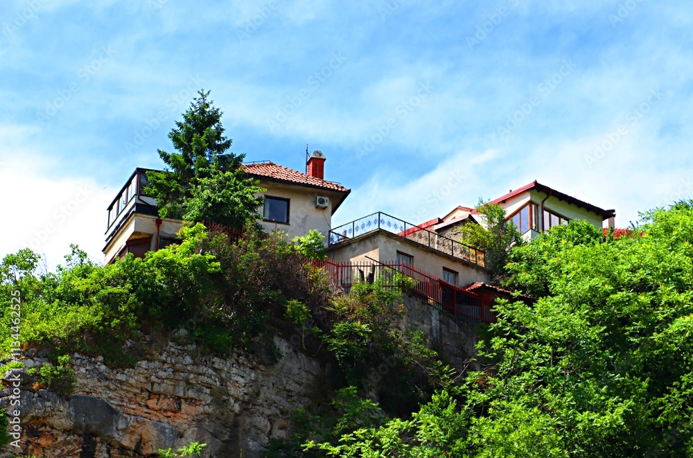 Residential buildings on the edge of a rocky mountainside in Sarajevo
