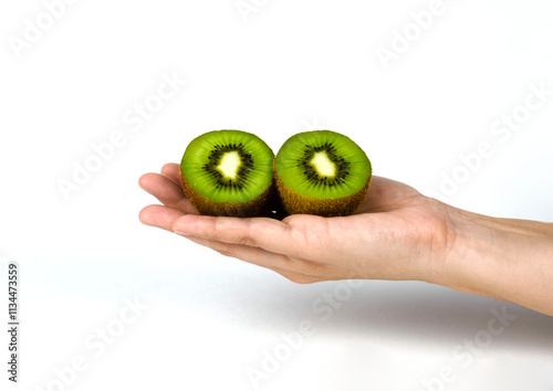 Sliced kiwi in hand isolated on white background.