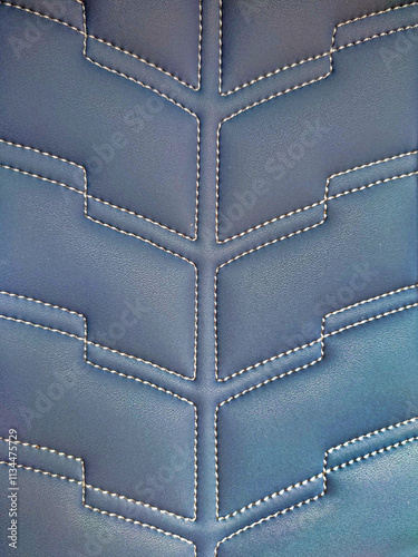 A pattern formed by the stitching design of a sofa chair.