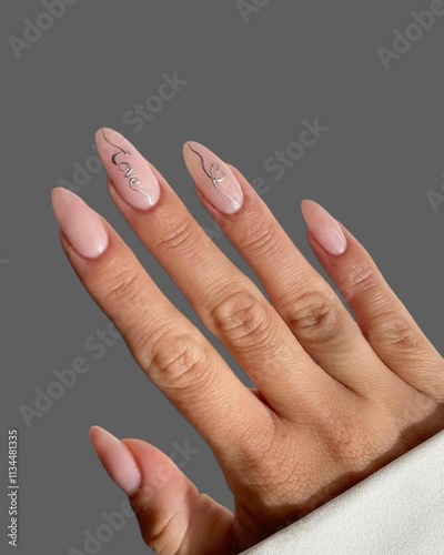 Hands and fingers of young woman with modern innovative nail manicure with different trendy drawings on gray background  photo