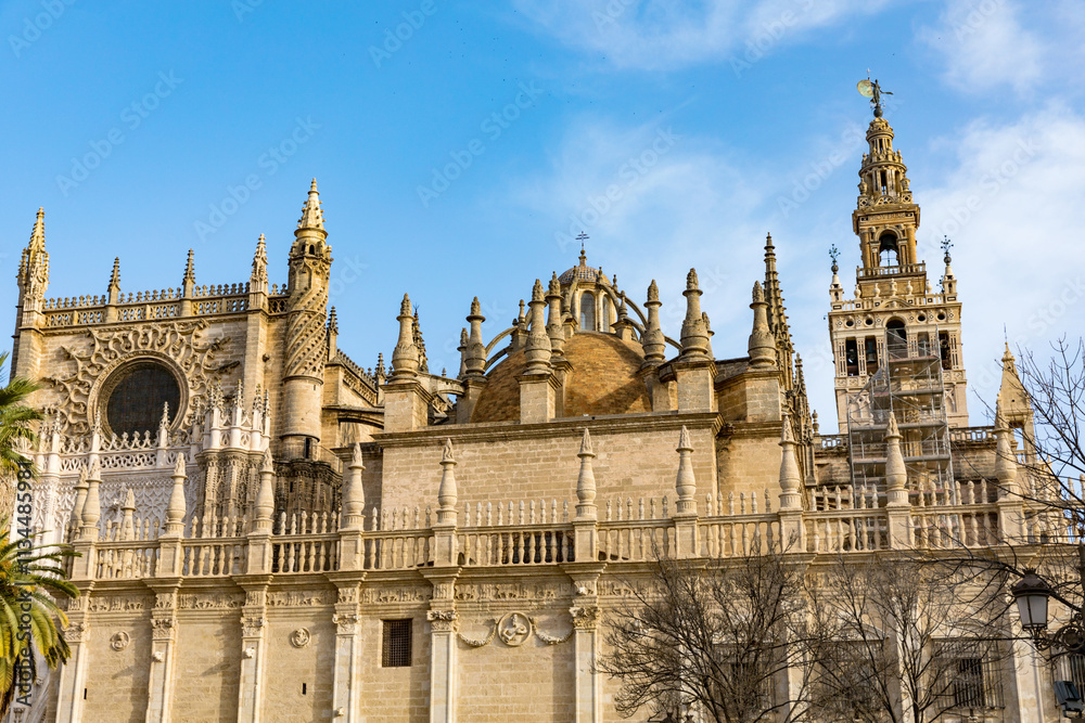 Fototapeta premium Seville cathedral Giralda tower of Sevilla Andalusia Spain Church on sunny day.