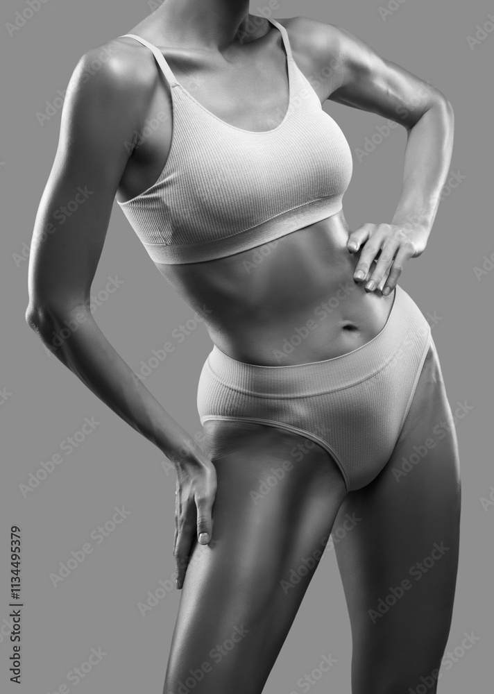 Naklejka premium A slender swarthy woman in underwear on a white background. Healthy lifestyle, sport and diet.