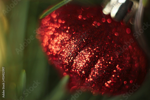 Red Christmas ball covered with glitter. Red glitter decoration macro photo. Shiny red surface macro photo. Christmas colors background