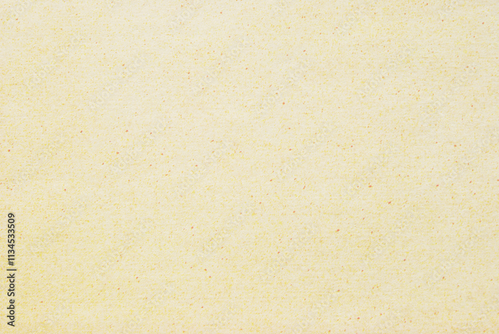 A sheet of spotted yellow recycled craft paper texture as background A sheet of spotted yellow recycled craft paper texture as background
